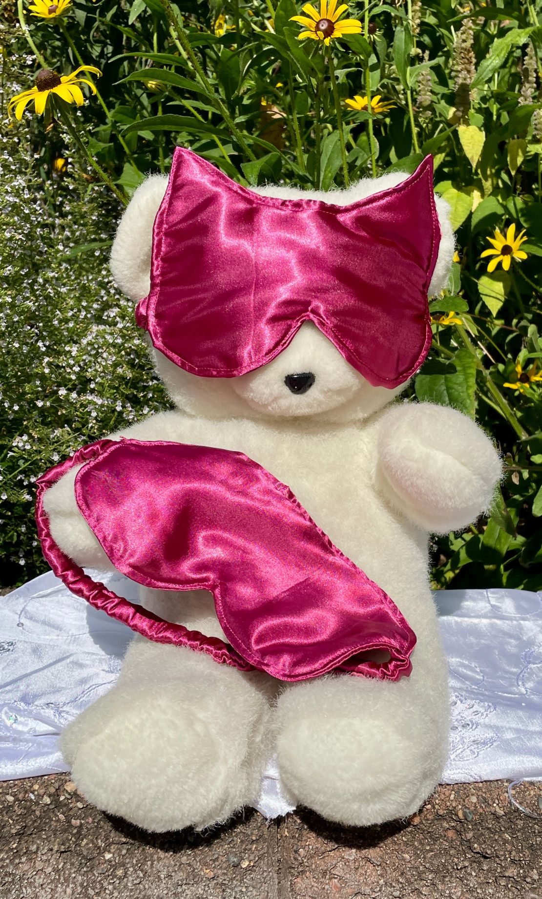 Teddy bear modeling a handmade satin sleep mask